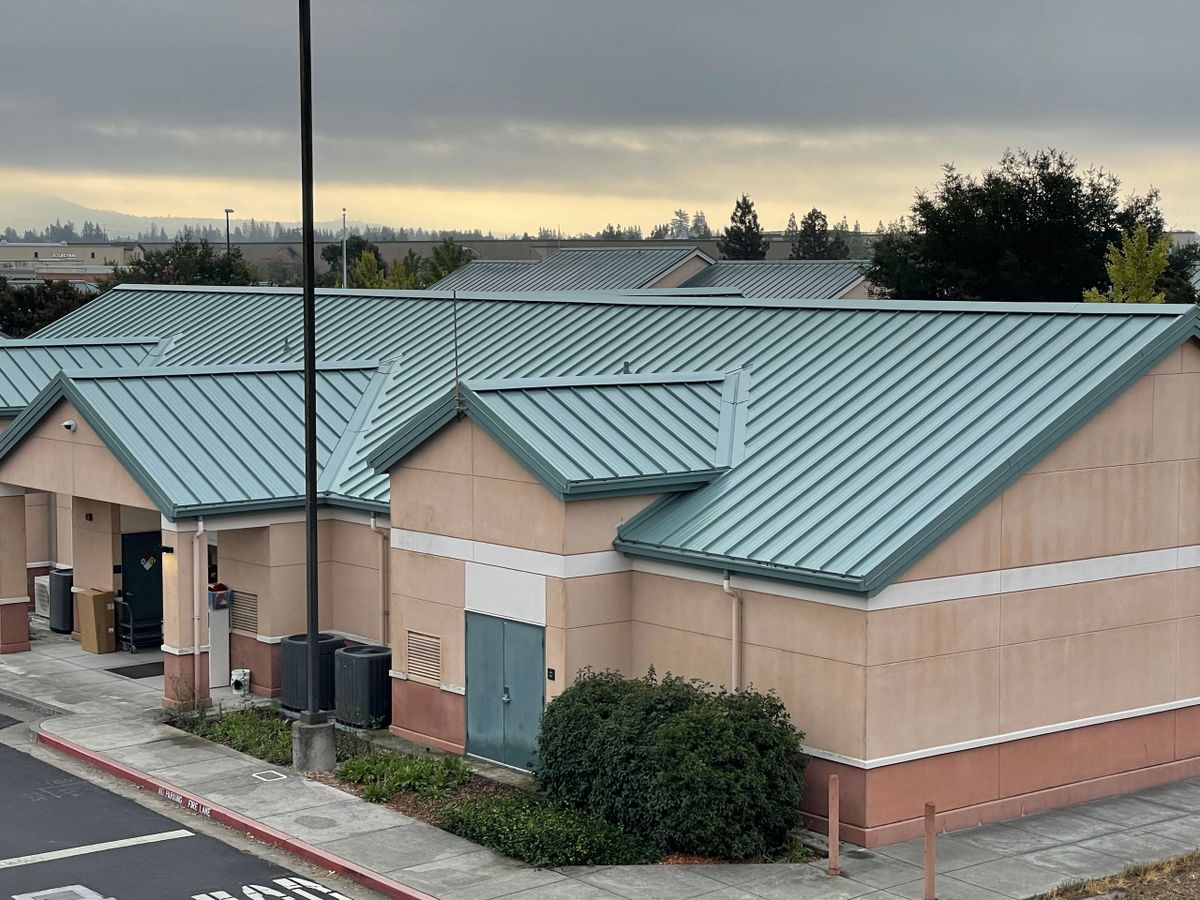 Standing seam metal roof installation on a commercial building